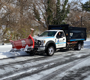a castle point plow moving snow off of a road